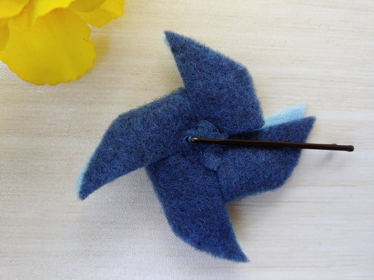 Handmade shades of blue pinwheel felt hair clip on a bobby pin, perfect for adding a pop of color and whimsy to any hairstyle - reverse side of hair clip.
