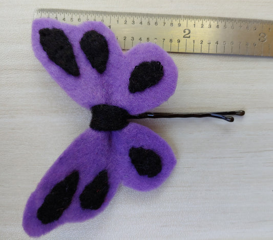 Handcrafted Purple Butterfly Felt Hair Clip featuring soft felt wings with black accents on a secure black bobby pin - next to ruler. A whimsical hair accessory.