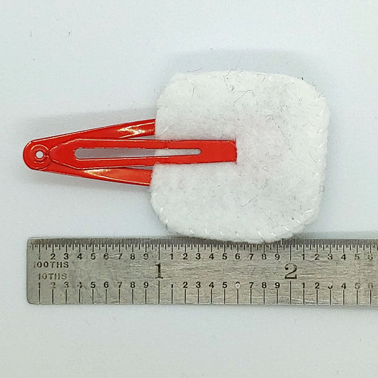 Handcrafted Snowman Felt Hair Clip featuring white felt, an orange nose, black embroidered details, and a snap clip. A fun winter accessory.