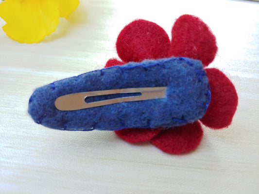 Handmade burgundy felt flower hair clip on a country blue snap clip. A stylish, elegant accessory for weddings, special occasions, or daily wear. Reverse side of clip.