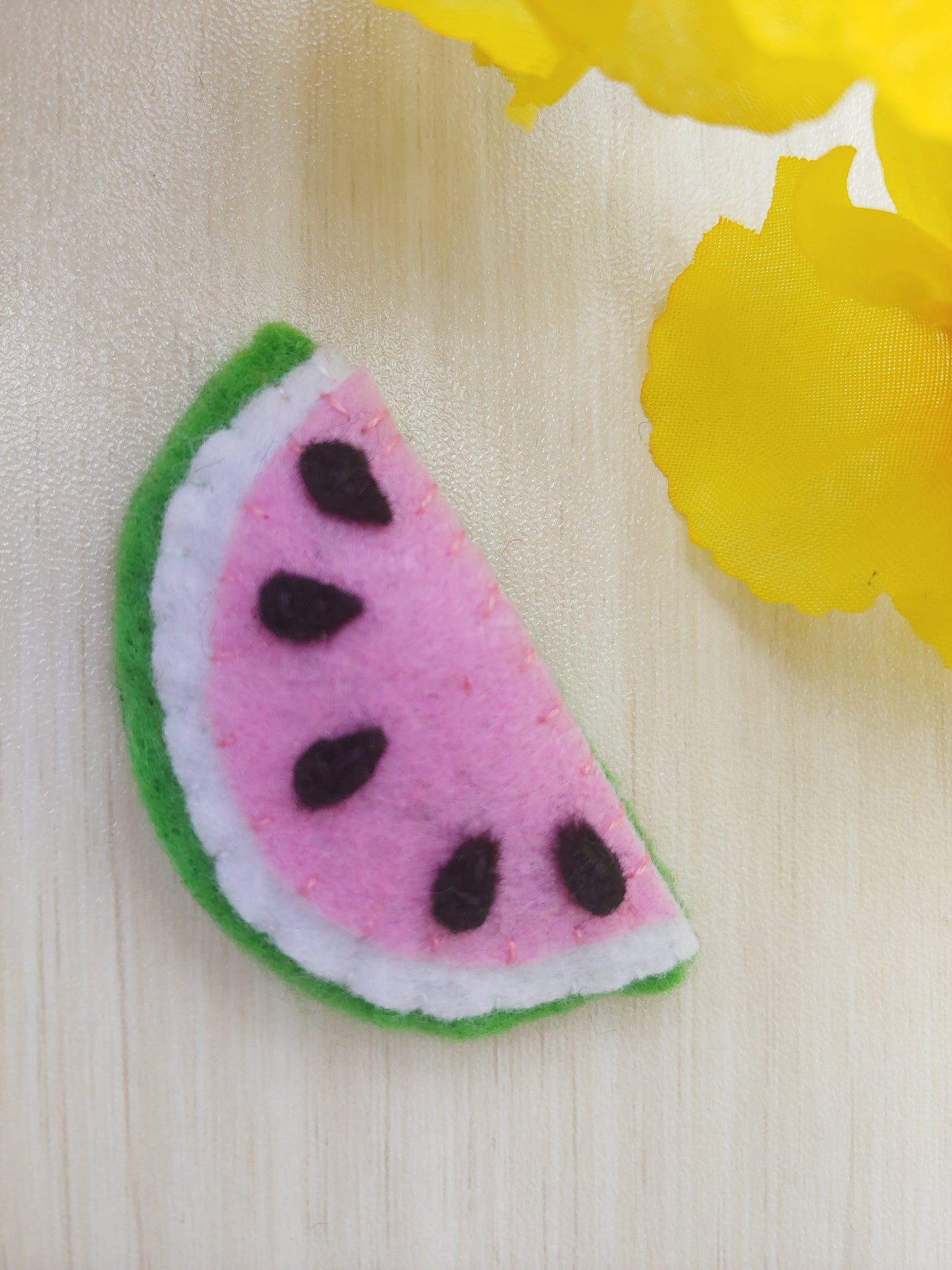 Handcrafted Watermelon Felt Hair Clip featuring bright pink, green, black, and white felt with a secure snap clip. A fun summer accessory.
