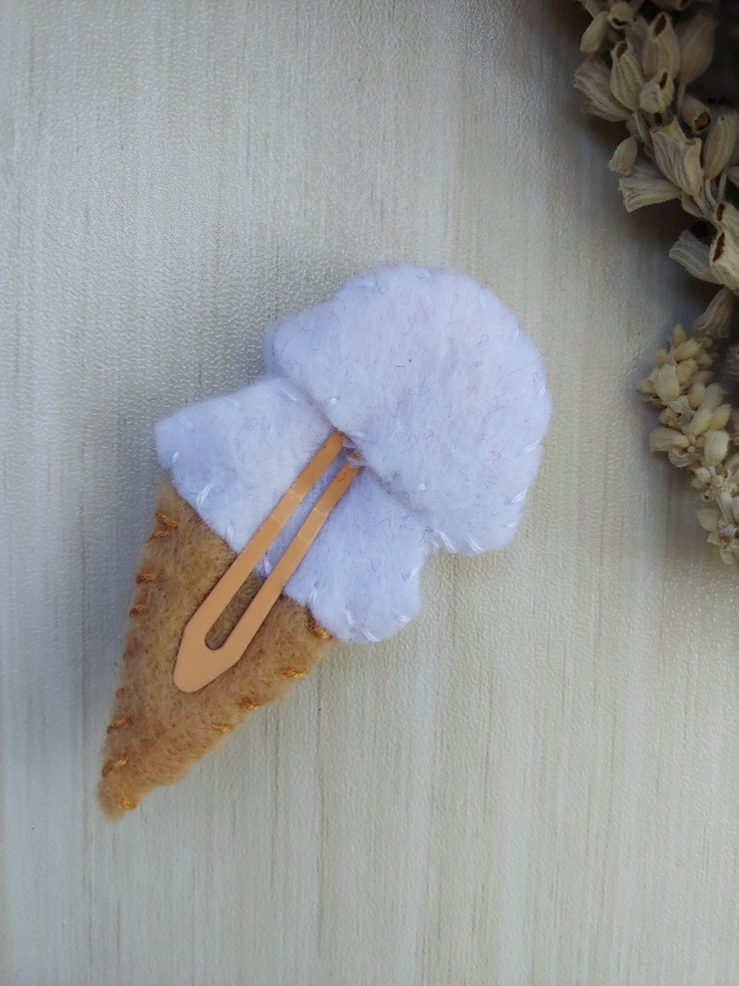 Handcrafted White Ice Cream Cone Felt Hair Clip featuring a tan cone, white scoops, and colorful sprinkles on a secure snap clip - back side of clip. A fun, sweet accessory.