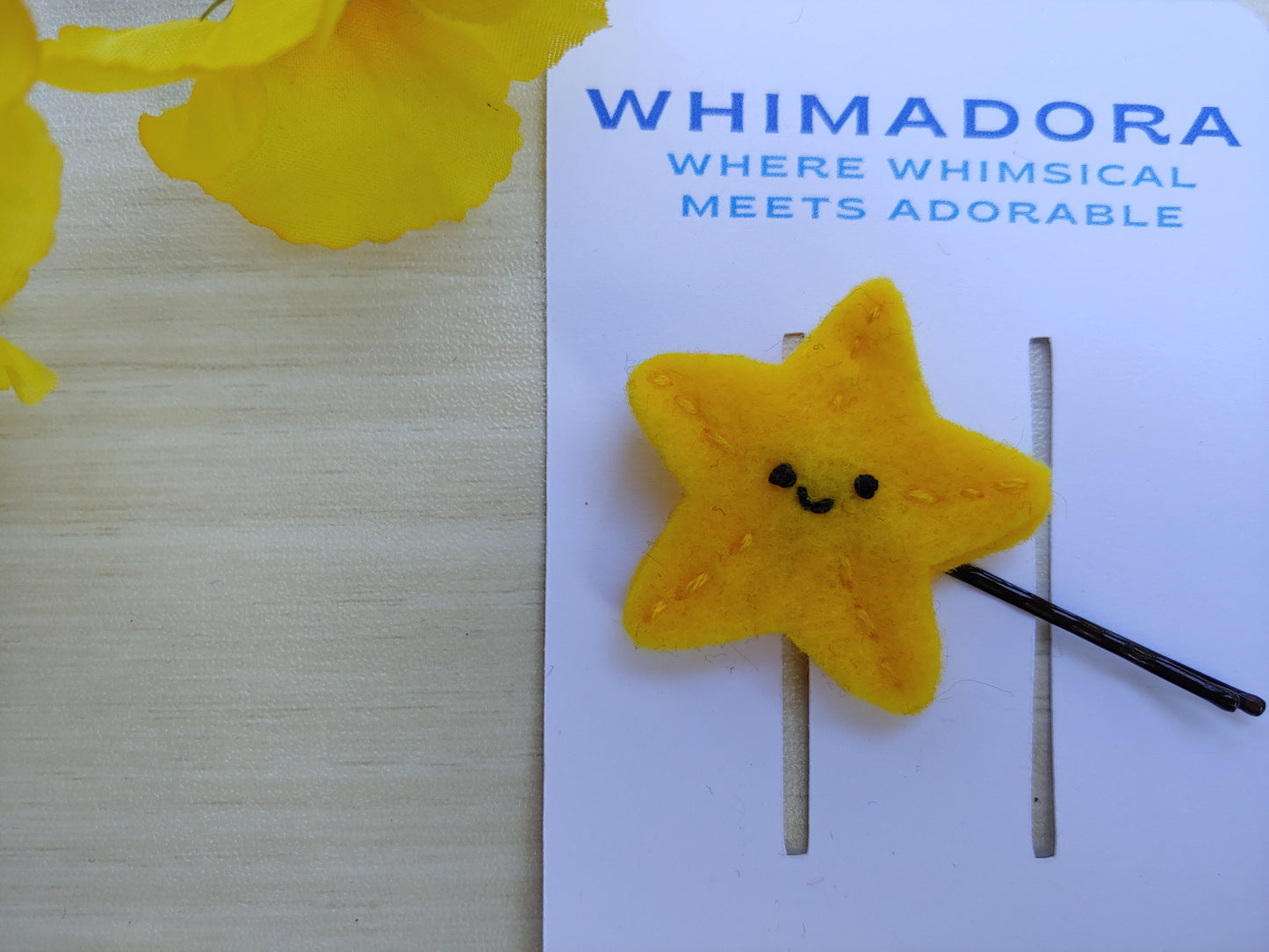 Handcrafted Star Felt Hair Clip featuring a cheerful smile, bright yellow felt, and a secure black bobby pin. A fun, quirky hair accessory.