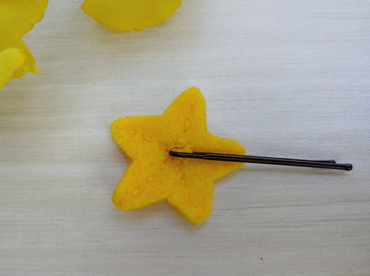 Handcrafted yellow Star Felt Hair Clip with a secure black bobby pin - reverse side. A fun, whimsical hair accessory perfect for all ages.