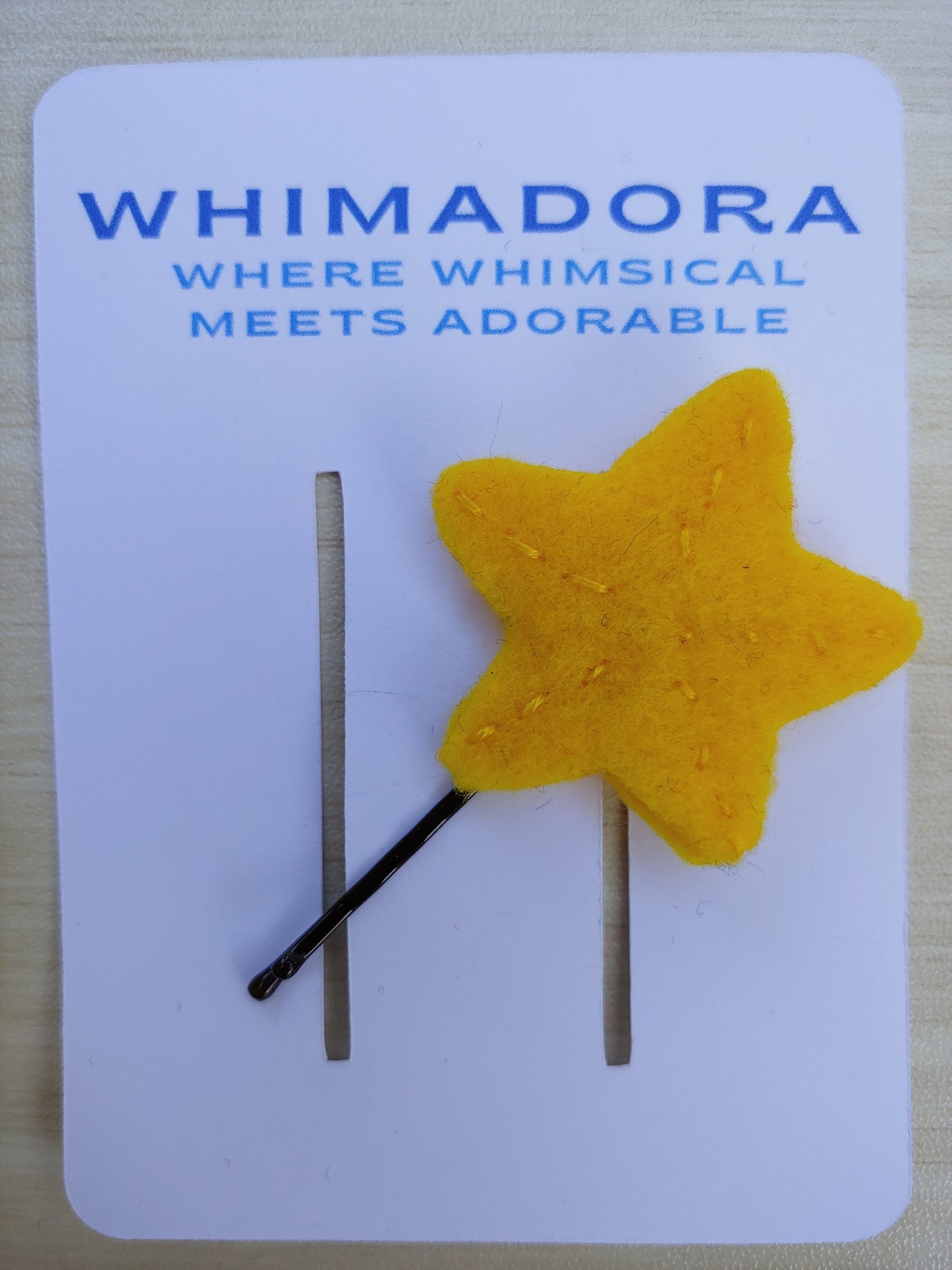 Handcrafted yellow Star Felt Hair Clip with a secure black bobby pin. A fun, whimsical hair accessory perfect for all ages.