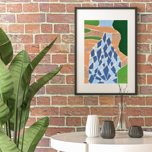 Framed abstract felt wall art of a waterfall at Cuyahoga Valley on a brick wall. Plant to the left and a table with vases below art.