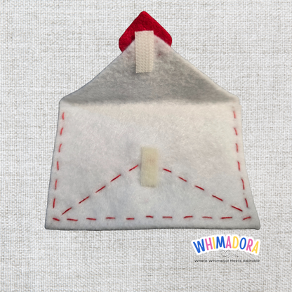 Felt house-shaped pouch with red roof on a textured gray background, branded 'WHIMADORA'.