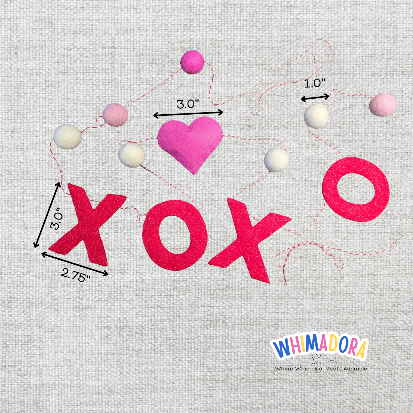 Embroidery design with 'XOXO' and a heart on a textured fabric background, featuring measurements and Whimadora branding.