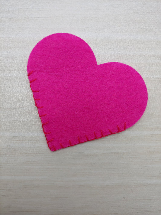 Felt cut in heart shape and stitched together on straight edge to form a corner.